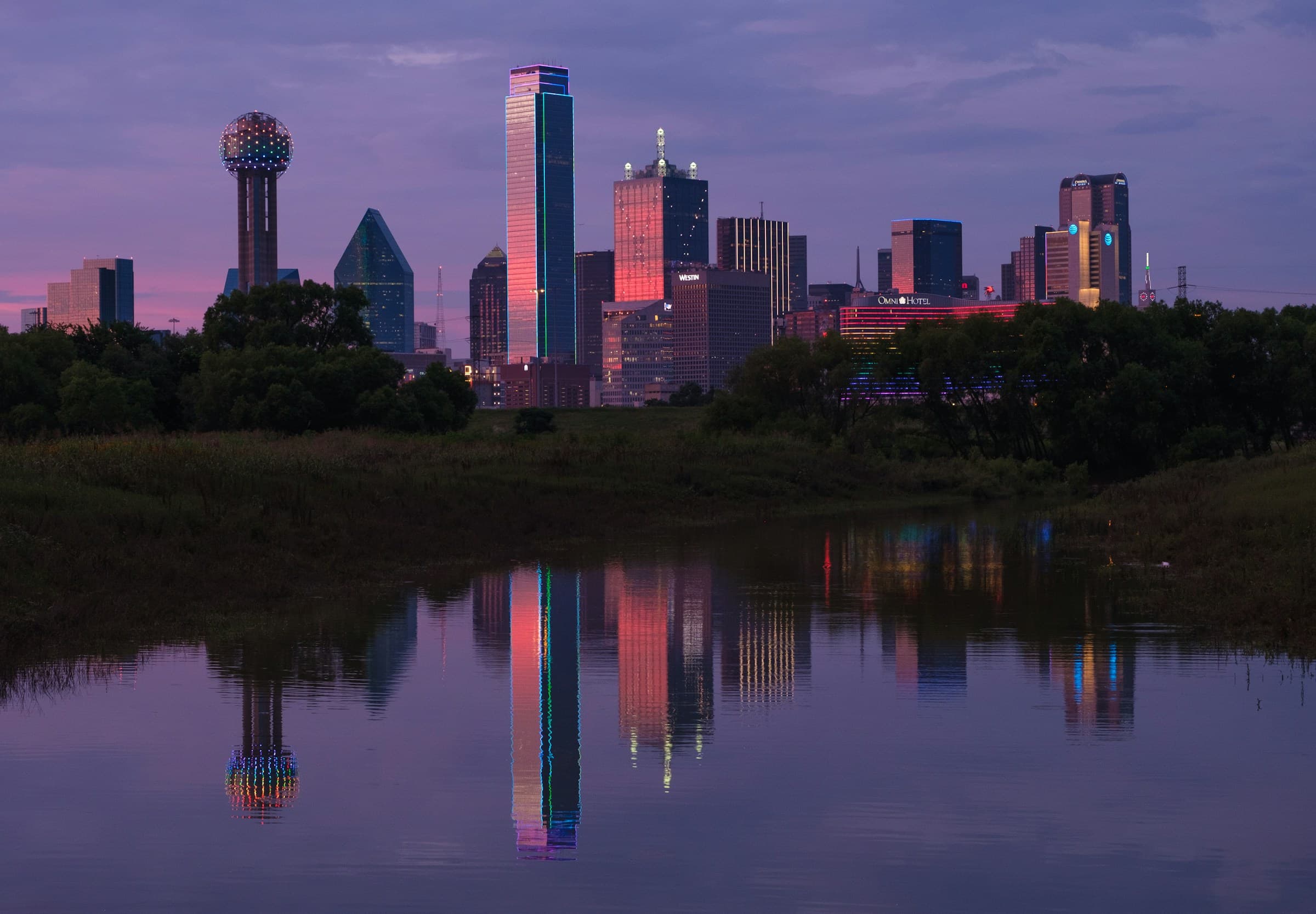 Dallas skyline reflected in still water at dusk