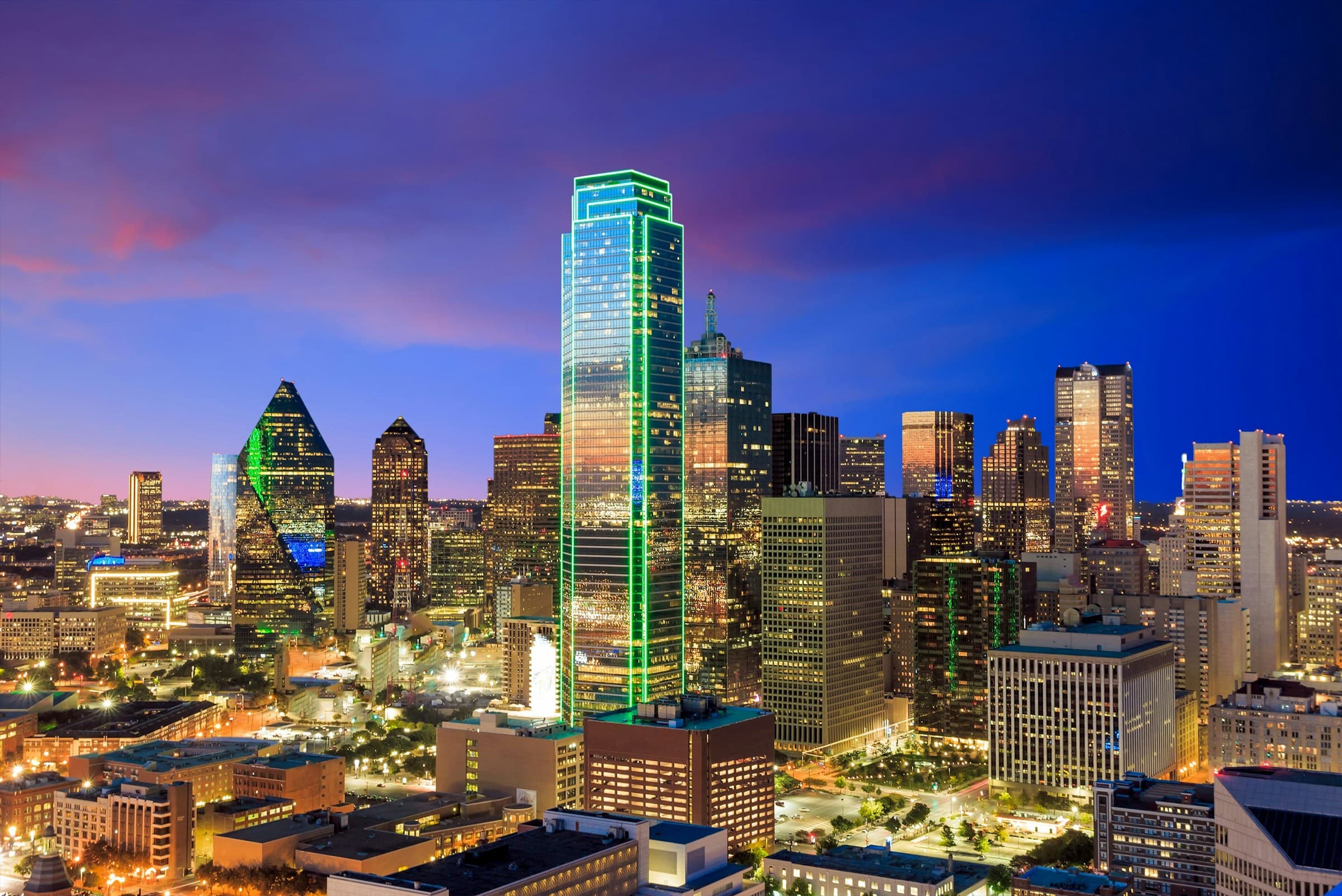 Downtown Dallas skyline at dusk, Bank of America Plaza lit green
